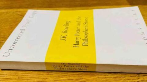 Harry Potter plain white paperback with yellow strip across the middle with author and title