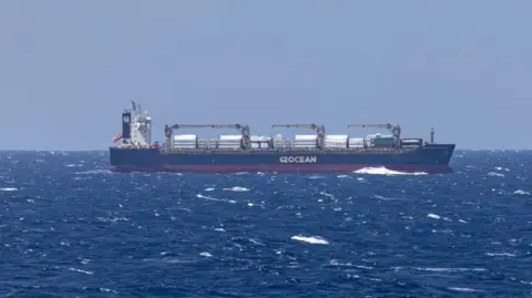 File photo showing a merchant ship seen from the USS Dwight D Eisenhower aircraft carrier during operations in the southern Red Sea, on 20 March 2024