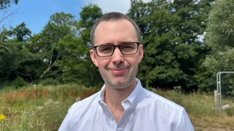 Jack Finnerty, who started a petition, looks straight at the camera.