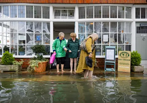 Peter Macdiarmid Women wade through floodwater in Bosham