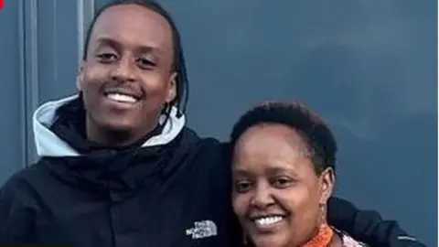Avon and Somerset Police Eddie Kinuthia with his arm around his mother, both smiling broadly