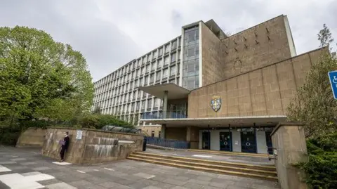 Durham County Council's offices at Aykley Heads. The building is seven storeys tall and made of brown stone.