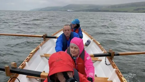 Wigtown Coastal Rowing Club A group of people rowing a boat