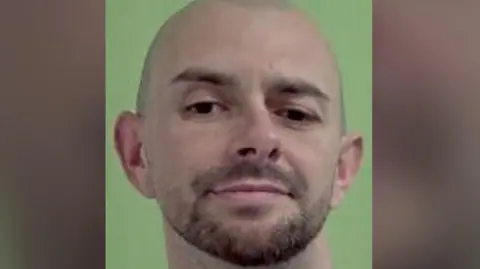 IOM POLICE A mugshot of Jamie Smith, a bald man with brown stubble.
