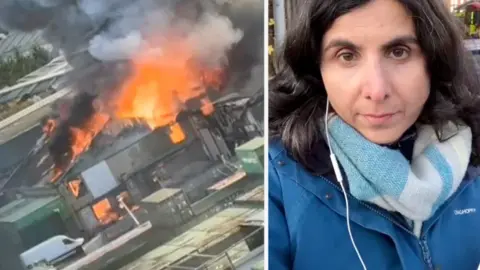 Flames and smoke emerged from a building on the left. BBC Reporter on the right.