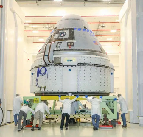 Boeing Starliner being pushed by engineers