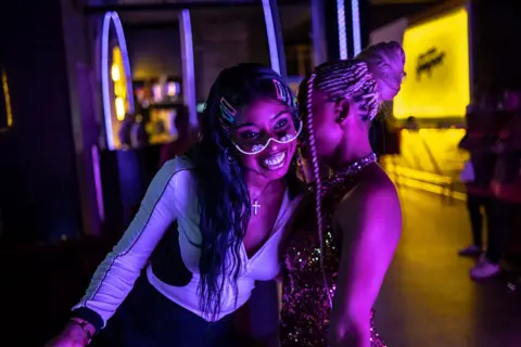 OLYMPIA DE MAISMONT / AFP / GETTY IMAGES  Guests react while dancing on the dance floor at Paper Nightclub in Abuja.