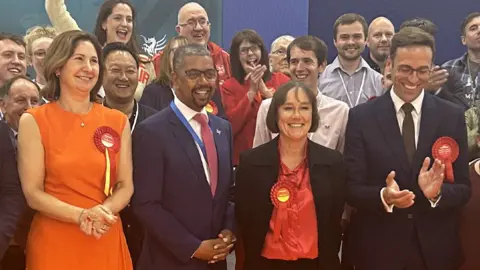 Wales' First Minister Vaughan Gething with winning Labour candidates and supporters at the count in Cardiff 