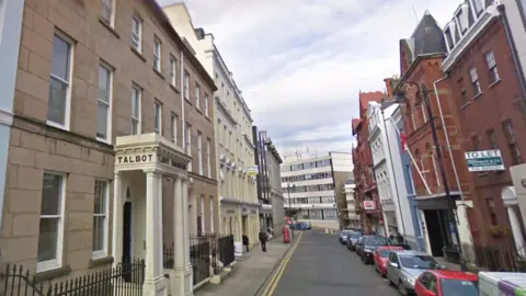 Google A brown terraced building, with an entrance that reads Talbot, with the street view of Athol Street with terraced buildings on either side.