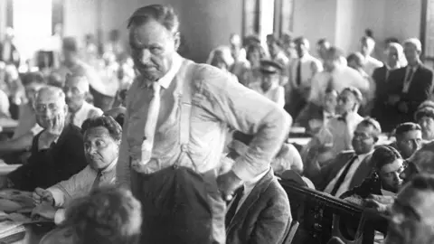 New York Daily News Archive / Getty Images Chicago trial lawter Clarence Darrow standing at the front of a court listening to a judge. It's an old black and white photo