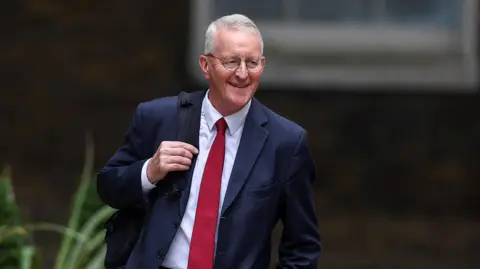 Reuters Hilary Benn holding a backpack on his way to 10 Downing Street