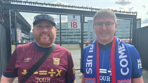 Harvey Bell/BBC James Laughlin (left) James Mower (right) outside the club wearing Ipswich Town football tops