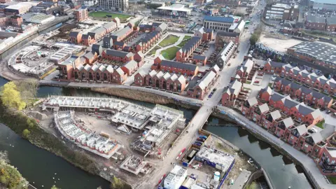 An aerial view of the latest developments at Waterside, with new homes under construction on an island