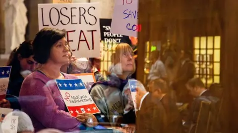 Reuters Demonstrators opposed to redistricting at the Indiana Statehouse in Indianapolis, Indiana, US, on 11 December 2025