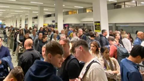 People queueing at Manchester Airport
