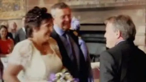 Caravan/Channel5 Paula Leeson in a wedding dress next to Donald McPherson during a wedding ceremony.