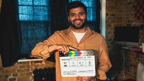 Juggy Sohal holding a film clapper board