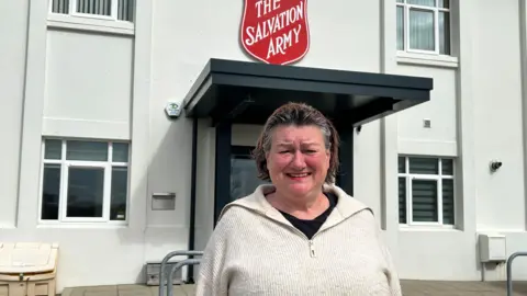 DEBBIE WHITE Vanessa Edwards, a woman with slicked back brown short hair, she has a bright smile and wears a white jumper.