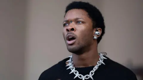 D4vd with mouth open, wearing chain necklace