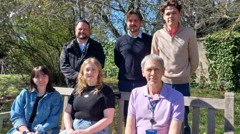 University of Leicester Image of volunteers from the University of Leicester sat on a bench in the sunshine