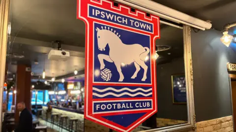 Shaun Whitmore/BBC Bar 21's interior with Ipswich Town decorations