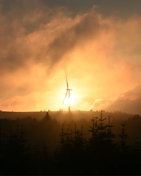 Callum Stephen A wind turbine at sunset with the sky and foreground visible