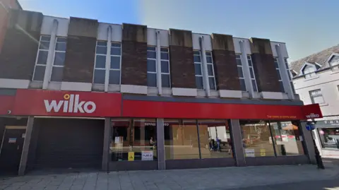 Google Shutters down on a Wilko's store with blue sky above