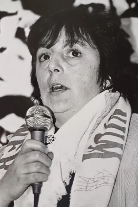 Ann Jones Ann Jones speaking into a microphone