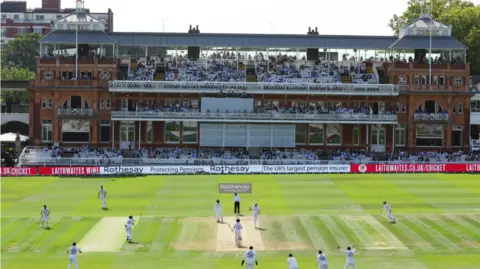 Reuters A landscape shot of the cricket pitch at Lords, with batters and fielders in position. 