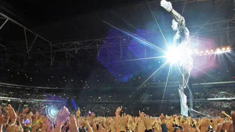 Getty A general view of the crowd and 60ft giant robot during the performance by Take That on the band's 'Progress' tour at Wembley Stadium, on July 9th 2011 in London