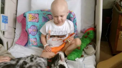 Family handout Cali in a hospital bed at the age of three after her diagnosis 