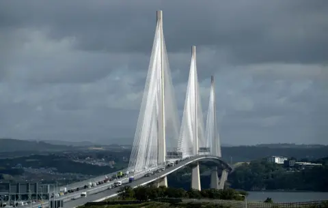 PA Media The 3  towers of the Queensferry Crossing with cables supported the arched emergence  of the motorway which is engaged  with traffic