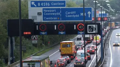 A wide shot of the M4 in Newport, showing a large number of cars driving down the three-lane road.