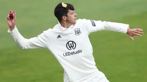 Gloucestershire's Dom Goodman throws a cricket ball