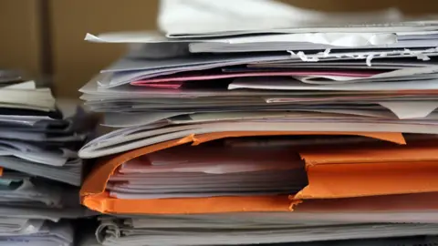 BBC A pile of messy paperwork and files