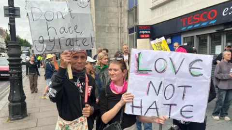 EDDIE MITCHELL A 'Love Not Hate' sign held by a counter-protester in Brighton