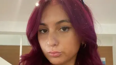 Supplied A young woman with red hair poses in a selfie