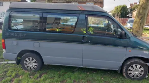 A black and grey Montague camper van