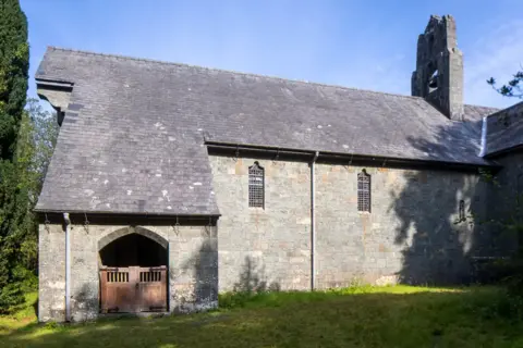 Andy Marshall St Mark's is a large grey stone building with a grey slate roof and stone bell tower 