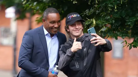 PA Media Former England captain Paul Ince has a selfie taken as he arrives at Chester Magistrates' Court charged with drink driving. 