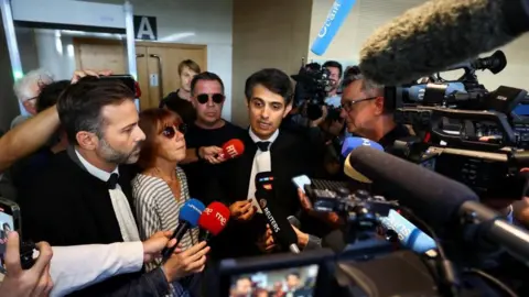 REUTERS/Manon Cruz Gisèle Pelicot surrounded by reporters