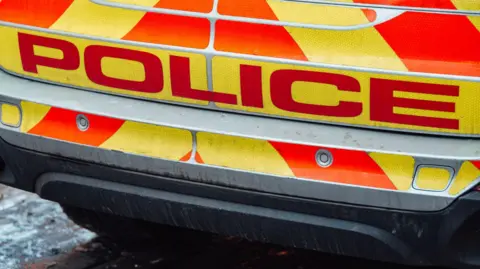 Getty Images A general view of the back and bumper of a UK police car, with writing that says "POLICE"