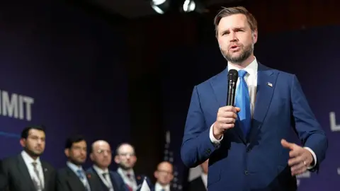 JD Vance speaking into a microphone