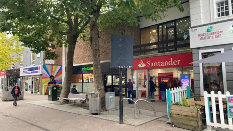 A pedestrianised high street lined with shops