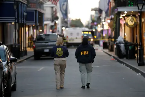 FBI agents walk near the site where people were killed by a man driving a truck in an attack during New Year's celebrations, in New Orleans, Louisiana, U.S. January 1, 2025