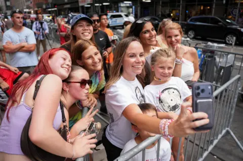 Reuters Taylor Swift fans pose for a selfie as they gather outside of Madison Square Garden, the venue for the reported wedding celebrations of singer Taylor Swift and National Football League (NFL) player Travis Kelce.