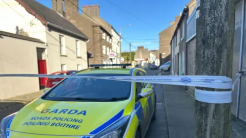 Cillian Sherlock/PA Wire A garda (Irish police) car parked at a cordon in New Ross, County Wexford where a young schoolgirl died after a fatal assault on Sunday 