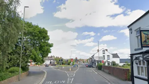 Google A single lane road that splits into two at some traffic lights