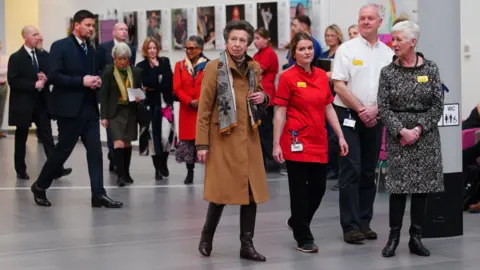 PA Media Princess Anne walking with health professionals through Southmead Hospital