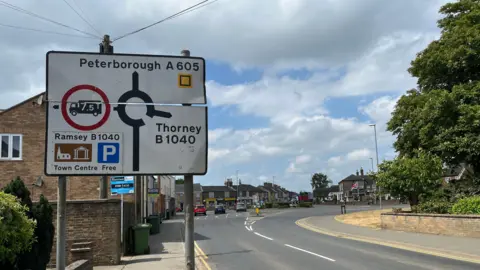 John Devine/BBC Road sign in Whittlesey directing people to Peterborough along the A605.